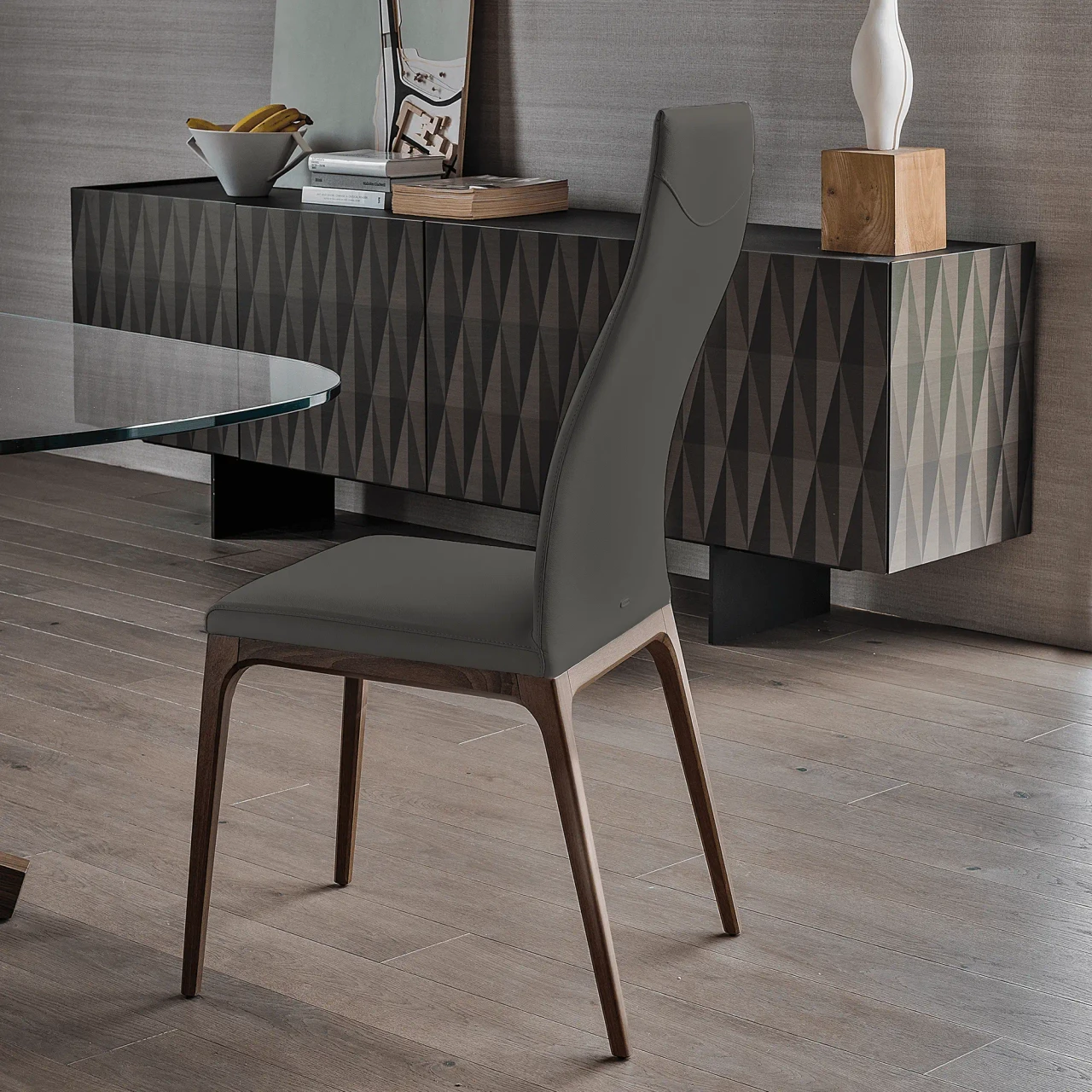 SMOKE || WENGHE - Cattelan Arcadia High Back Chair in Smoke Soft Leather 952 with Wenghe Stained Beech Frame, side view in dining room setting.