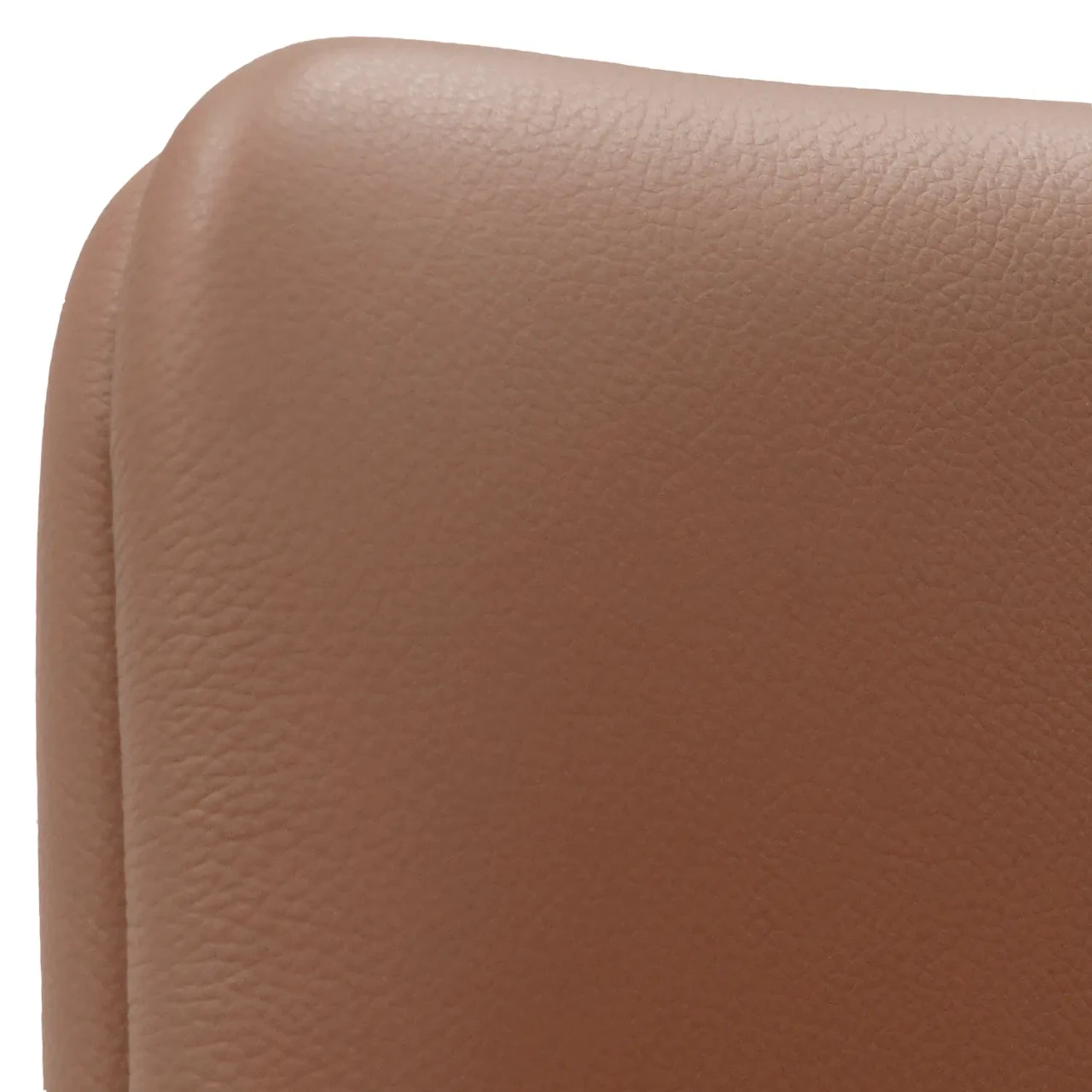 COGNAC LEATHER || Closeup - Close-up side view of a tan leather modern chair showing detailed grain and rounded corner stitching.