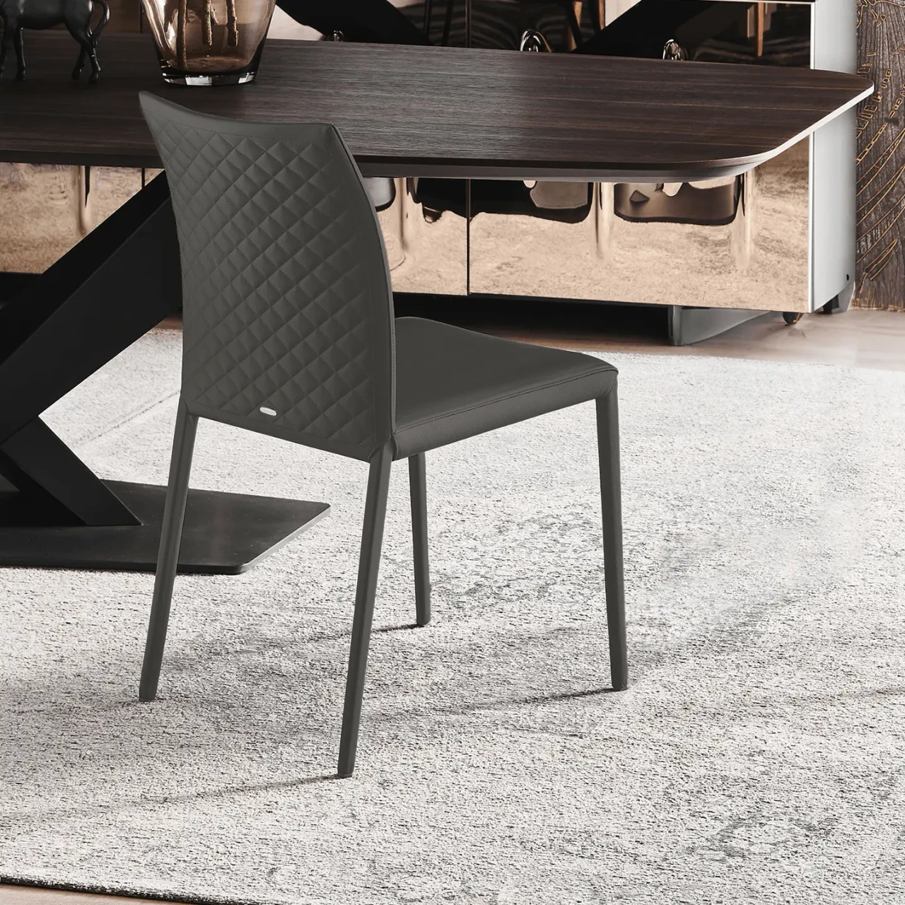 SMOKE - Cattelan Norma Couture Side Chair in Smoke Soft Leather with diamond tufted back, side view in a dining room setting.