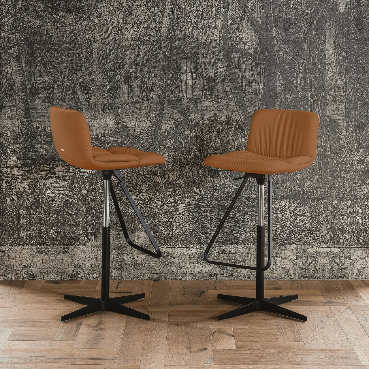 COGNAC - Two Cattelan Axel X Bar Stools in Cognac Soft Leather with Black Spoke Base, front view in a dining room setting.