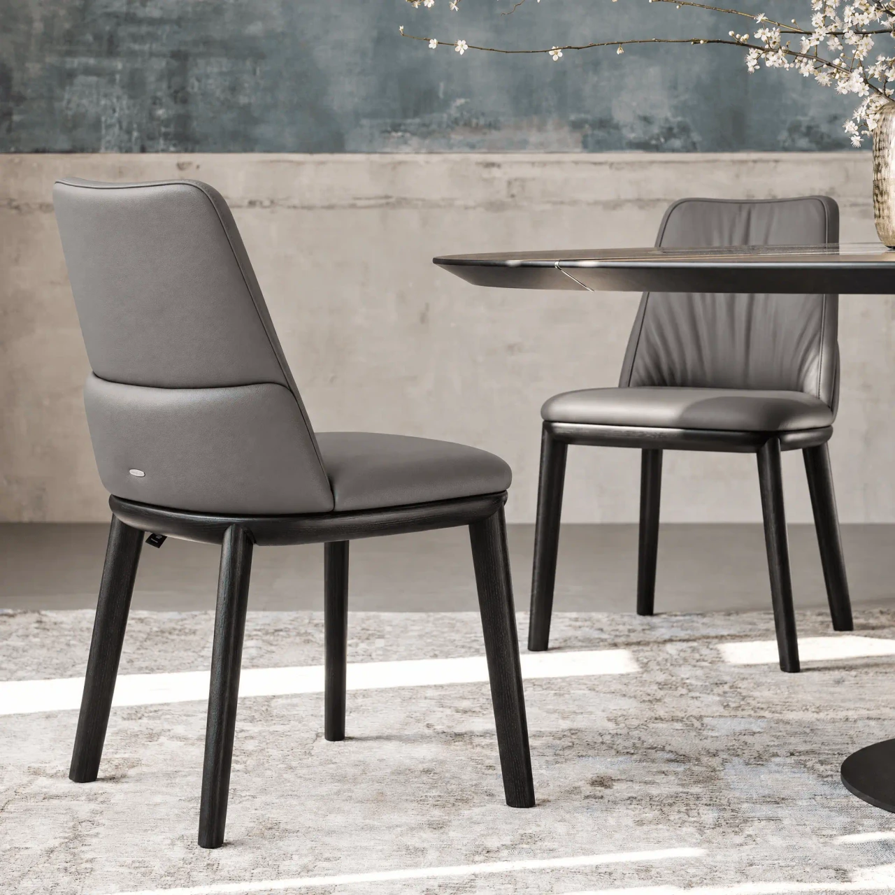 Cattelan Belinda Side Chair in Argilla soft leather with black stained ashwood frame, side view in dining room setting.