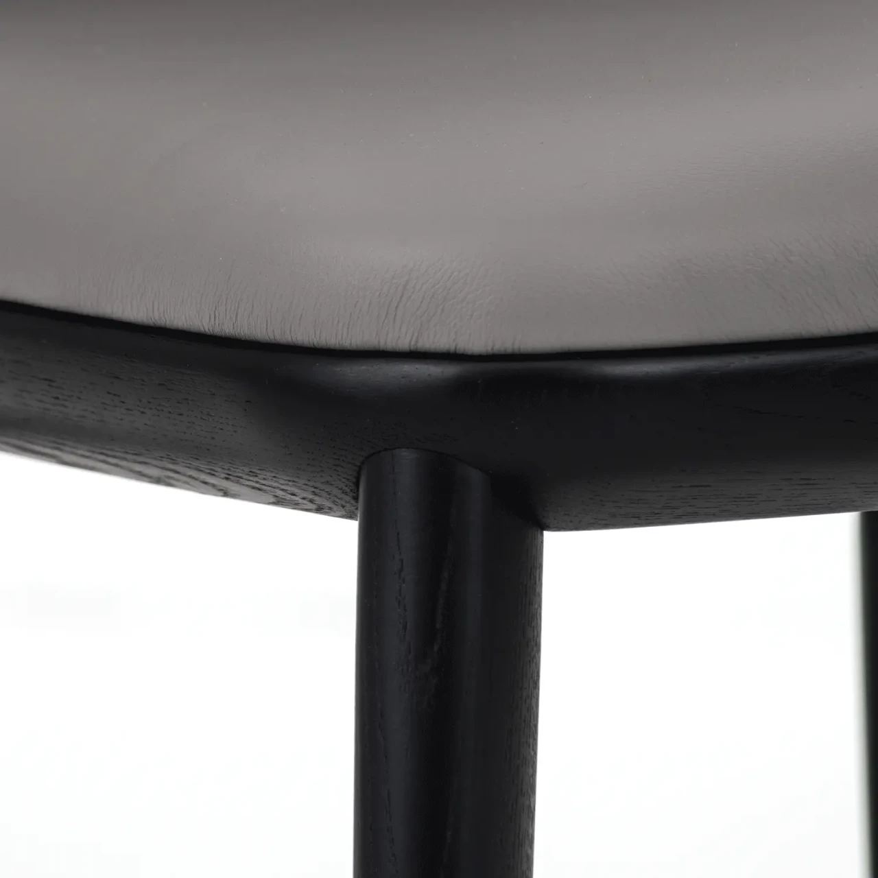 Closeup - Close-up of Cattelan Belinda Side Chair with Argilla soft leather seat and black stained ashwood frame.