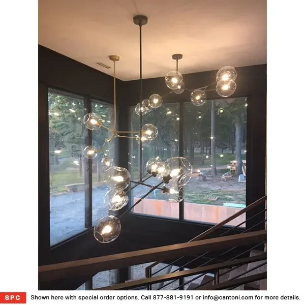 Covington 5-light Pendant in Dark Bronze with glass globes, modern style, hanging in a living room, eye-level view.