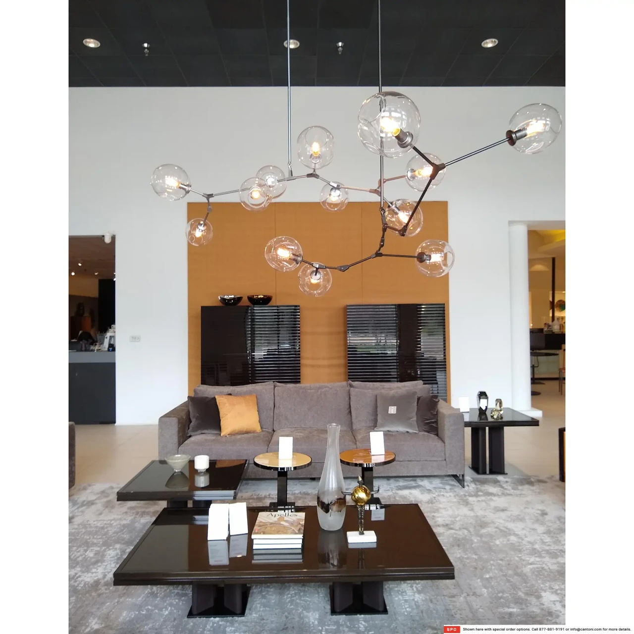 Covington 5-light Pendant in Dark Bronze with glass globes, modern style, living room setting, front view.
