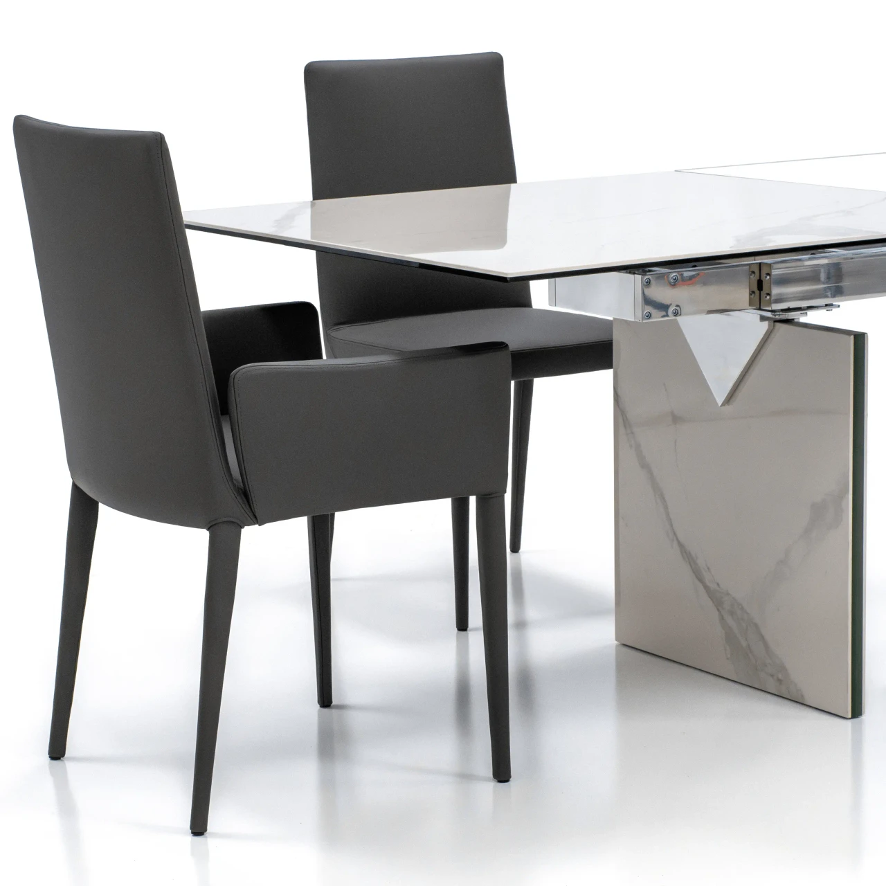 GREY LEATHER - Frag Bella Hp Arm Chair, modern dark grey leather dining chair with armrests, side view next to a marble dining table.