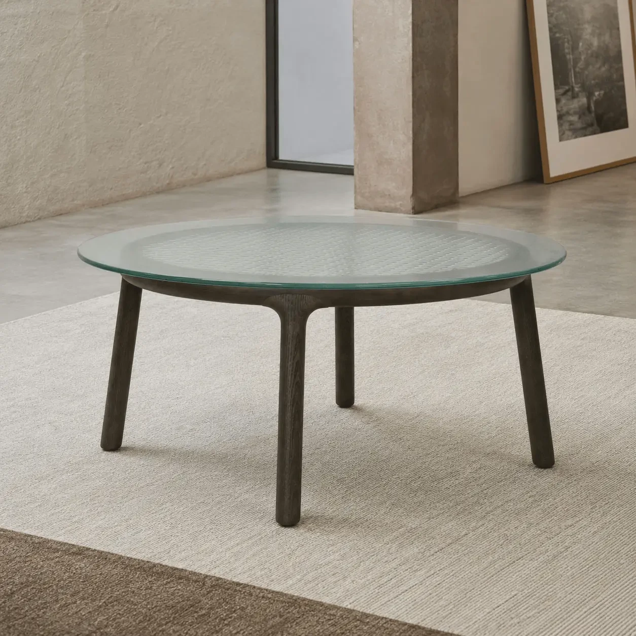 Fiam Cannage Cocktail Table in living room, fused transparent glass top, solid tobacco oak frame, angled front view.