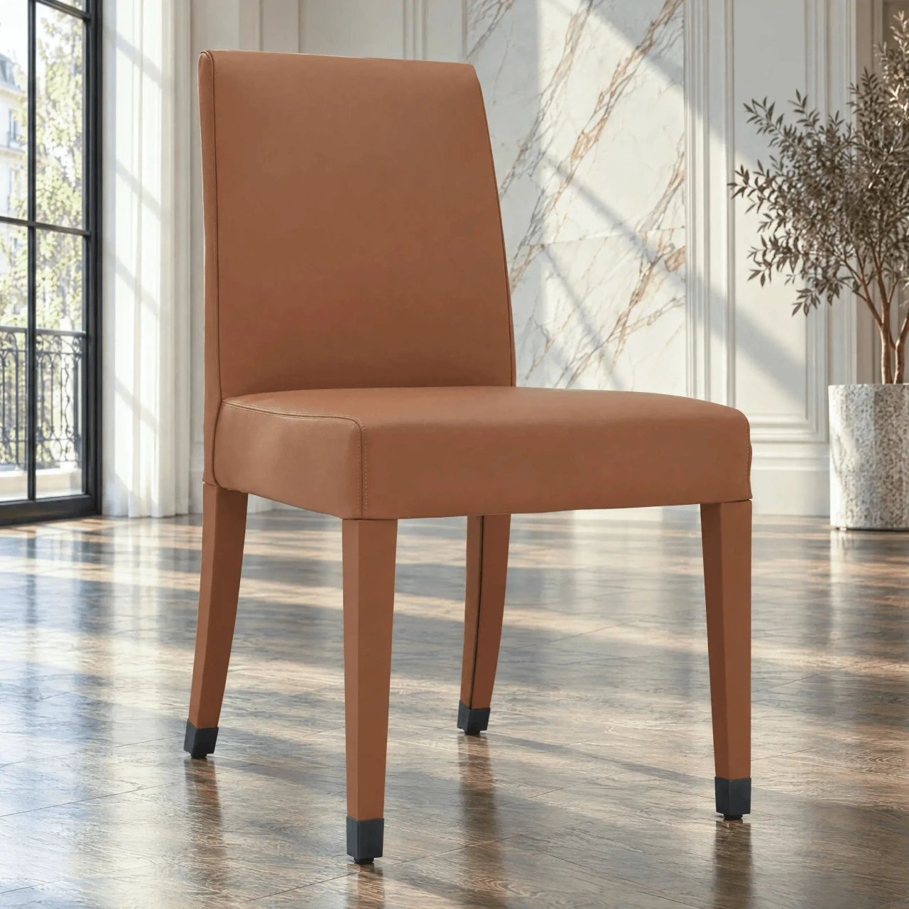 Malerba Perfect Time Side Chair in Cognac leather with bronze leg caps, modern style, 3/4 view in a dining room setting.