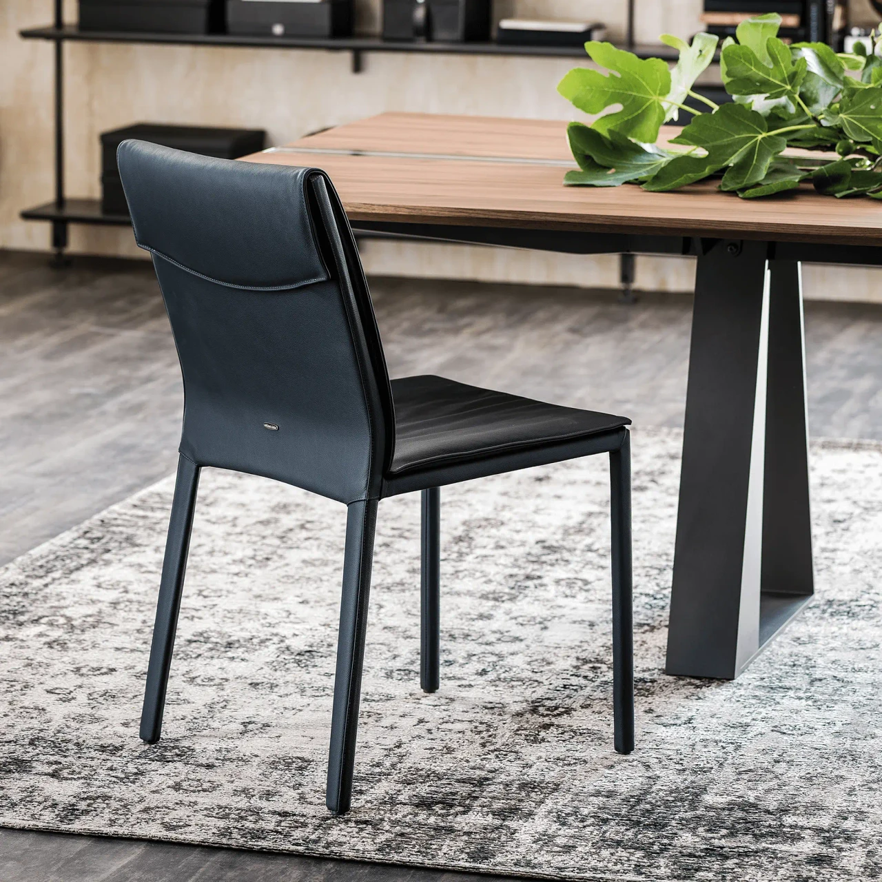 NERO - Cattelan Isabel Side Chair in Nero Soft Leather, modern style, black leather and metal, 3/4 rear view in dining room setting.