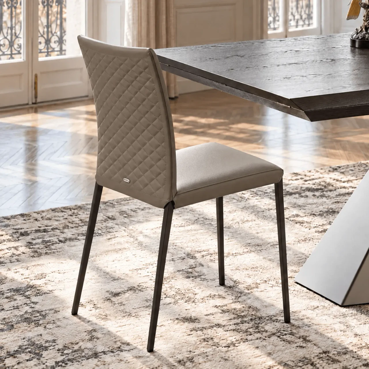 CASTORO - Cattelan Norma Ml Couture side chair in Castoro soft leather with diamond tufted back, side view in dining room setting.