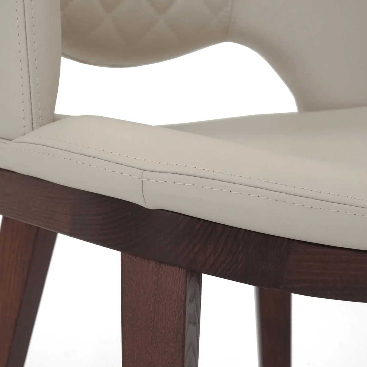 IVORY || Closeup - Close-up side view of Fashion Q Side Chair with ivory leather seat and Noce Canaletto wood frame.