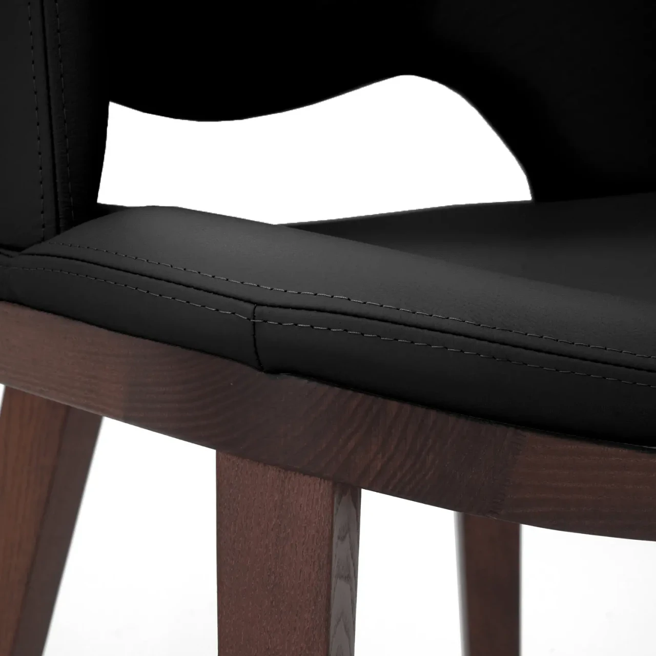 BLACK || Closeup - Close-up side view of Fashion Q Side Chair with black leather seat and Noce Canaletto wood frame.
