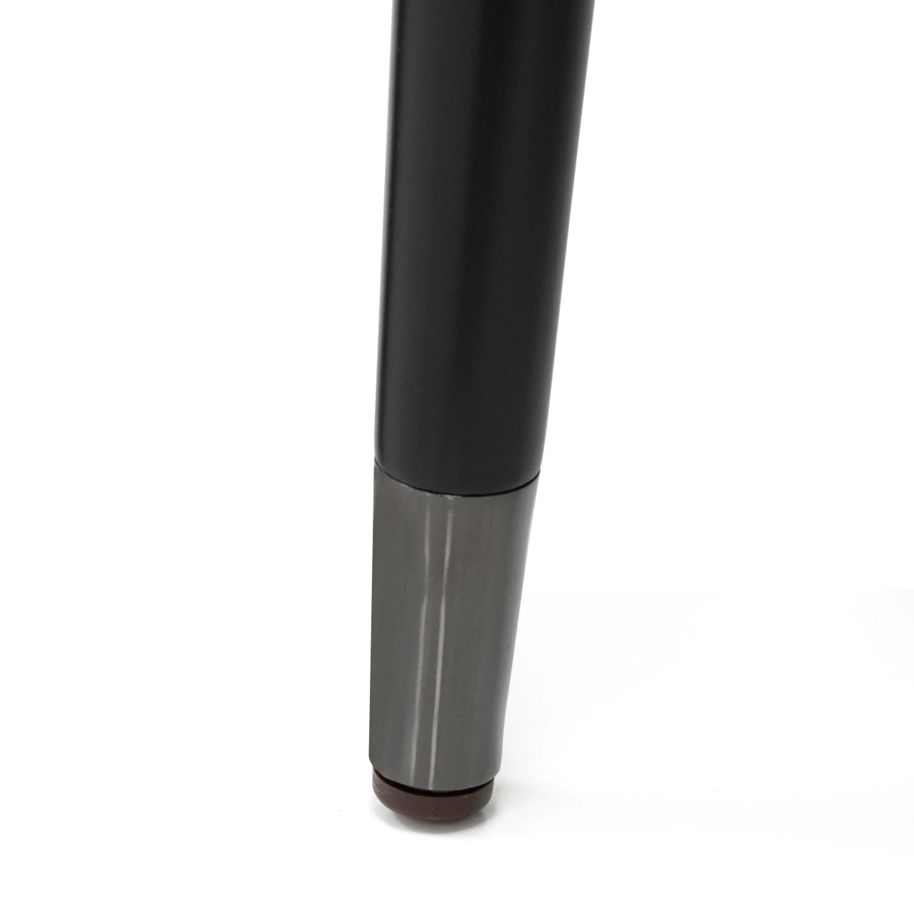 Closeup - Malerba Next Level Arm Chair leg, matt black wood frame with black chrome leg caps, close-up bottom angle view