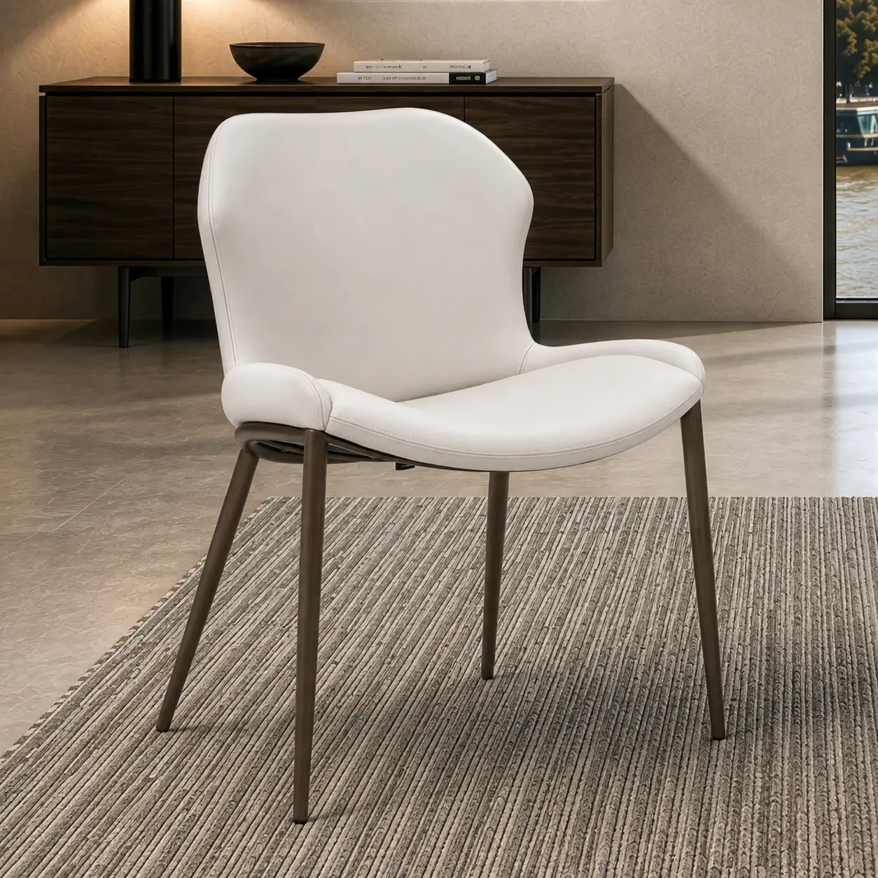 CANOVA - Cattelan Rachel Ml Side Chair in Canova Soft Leather with Bronze Embossed Steel Legs, 3/4 view in a modern dining room.