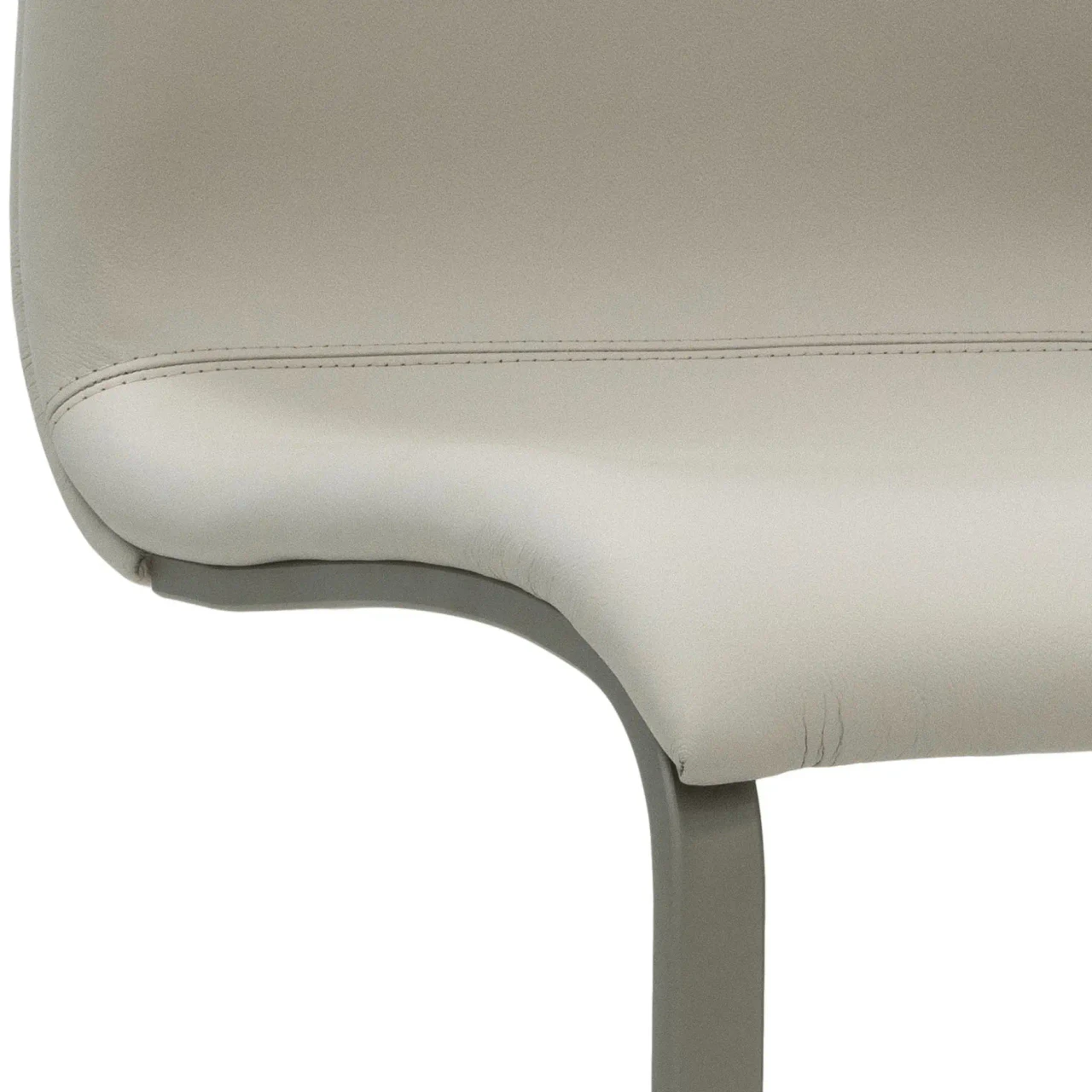Closeup - Close-up side view of Toro Side Chair in beige leather with titanium powder coat frame.
