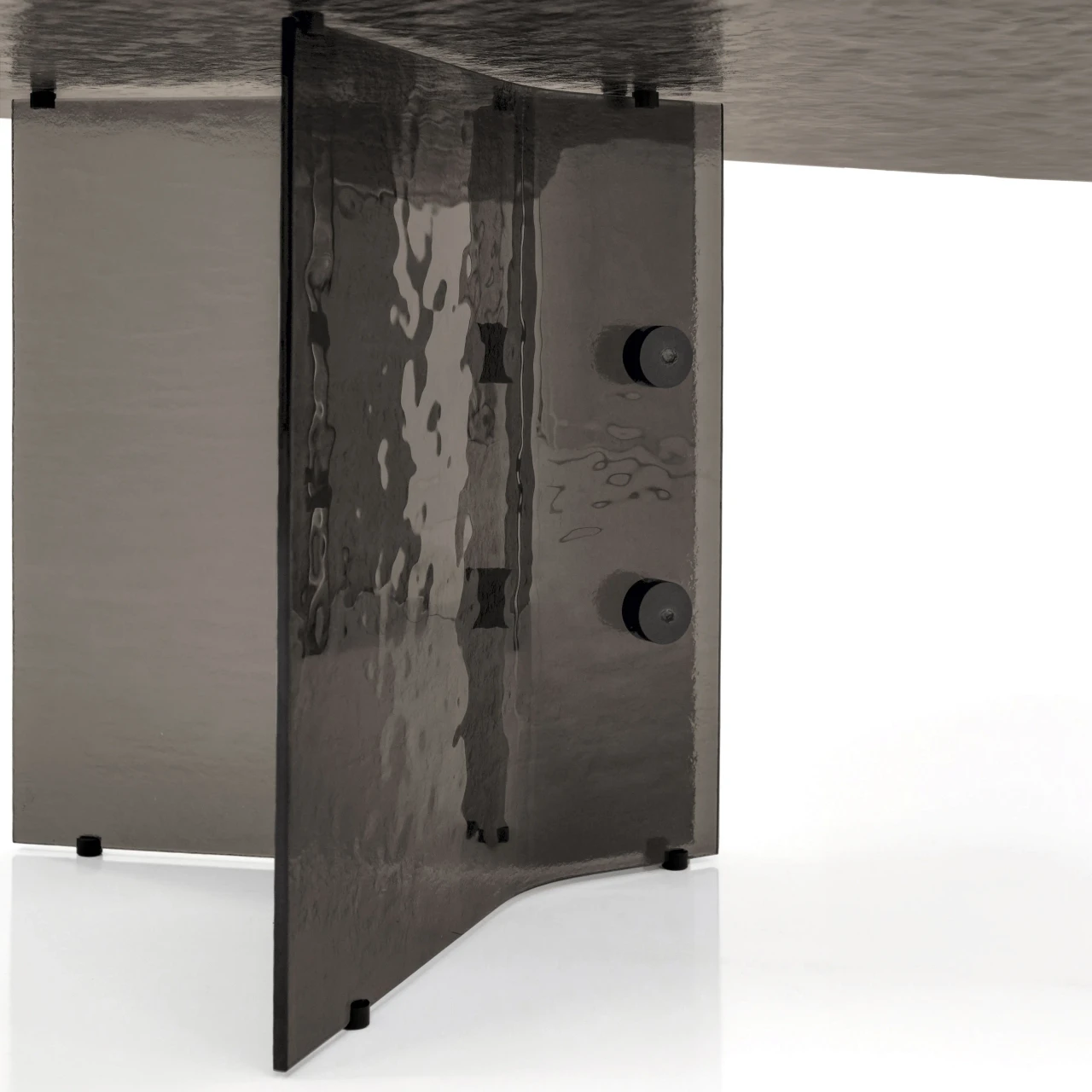 96.5 IN || Closeup - Close-up side view of a modern grey smoked glass table base with visible hardware and polished edges.