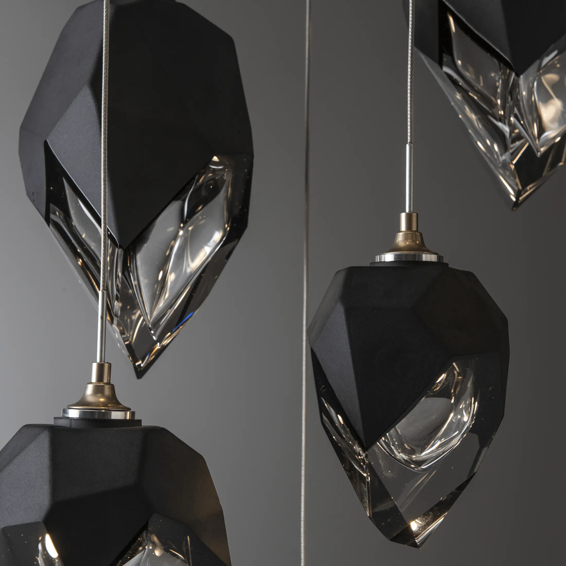 Chysalis 9-light Mix Pendant, modern black polished crystal and brass finish, geometric design, close-up angle.