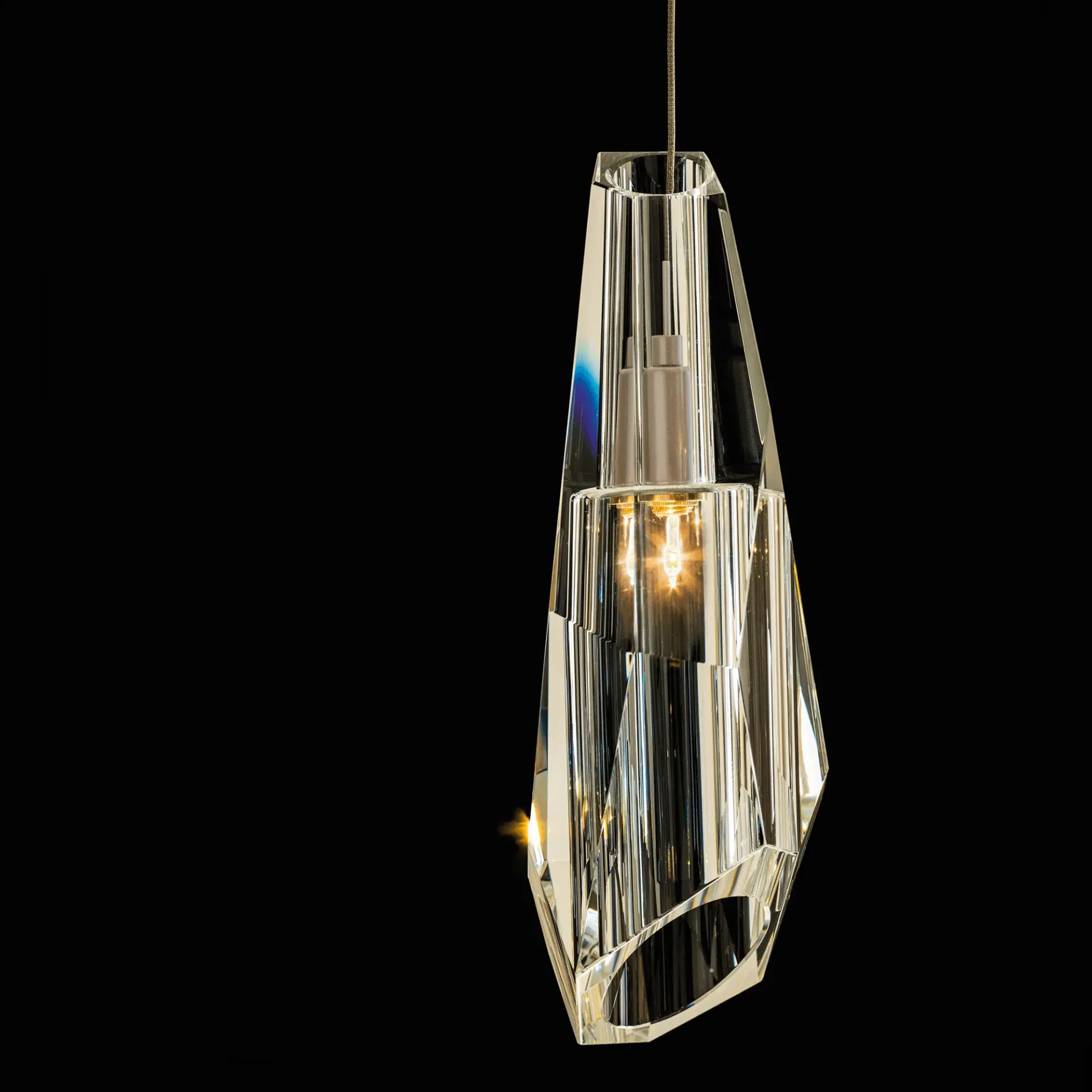 Luma Mini Pendant, modern crystal pendant light in soft gold finish, faceted glass design, front view on black background