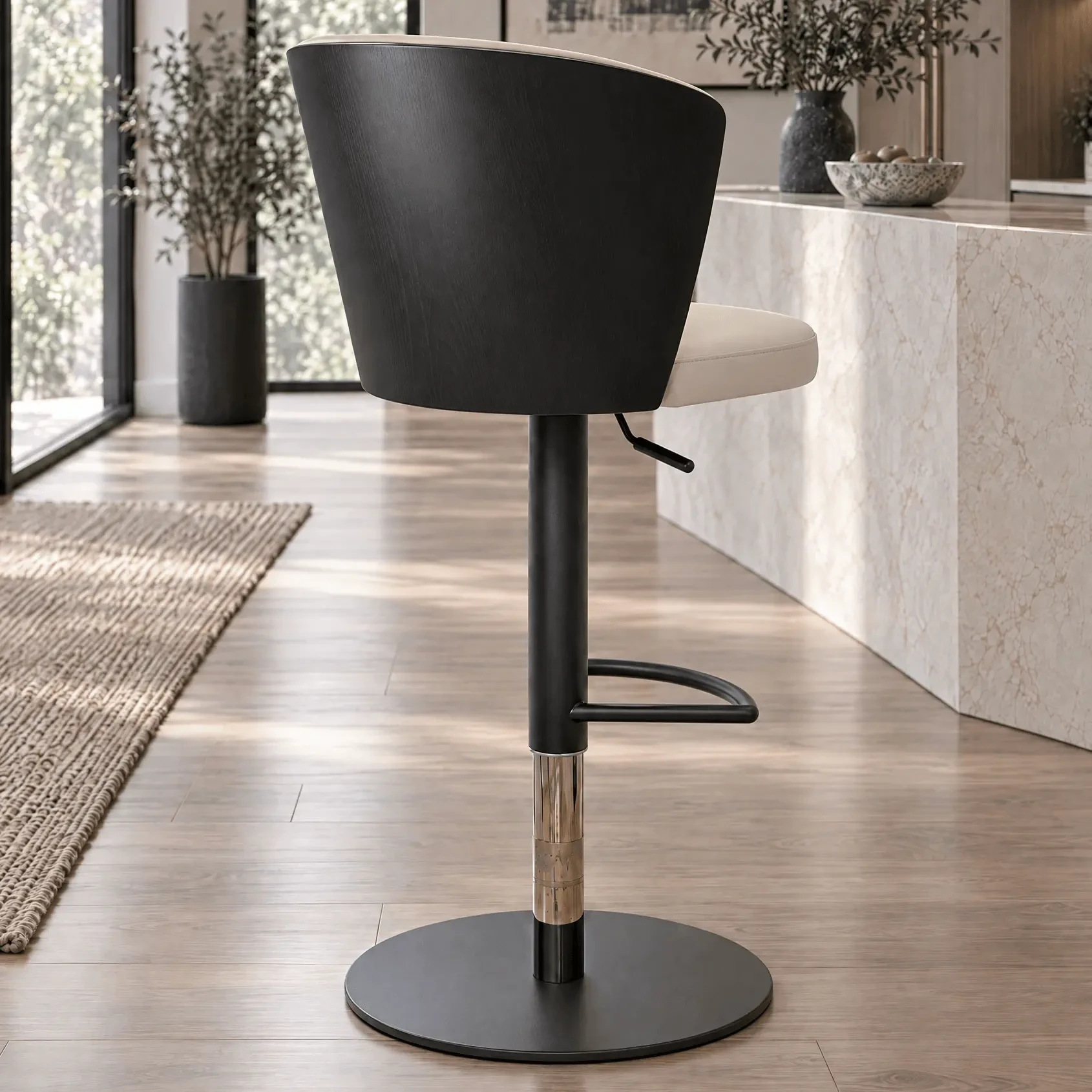 Tess Bar Stool in Black Ash and Black Leather with black base and chrome gas lift, rear view in a modern kitchen setting.
