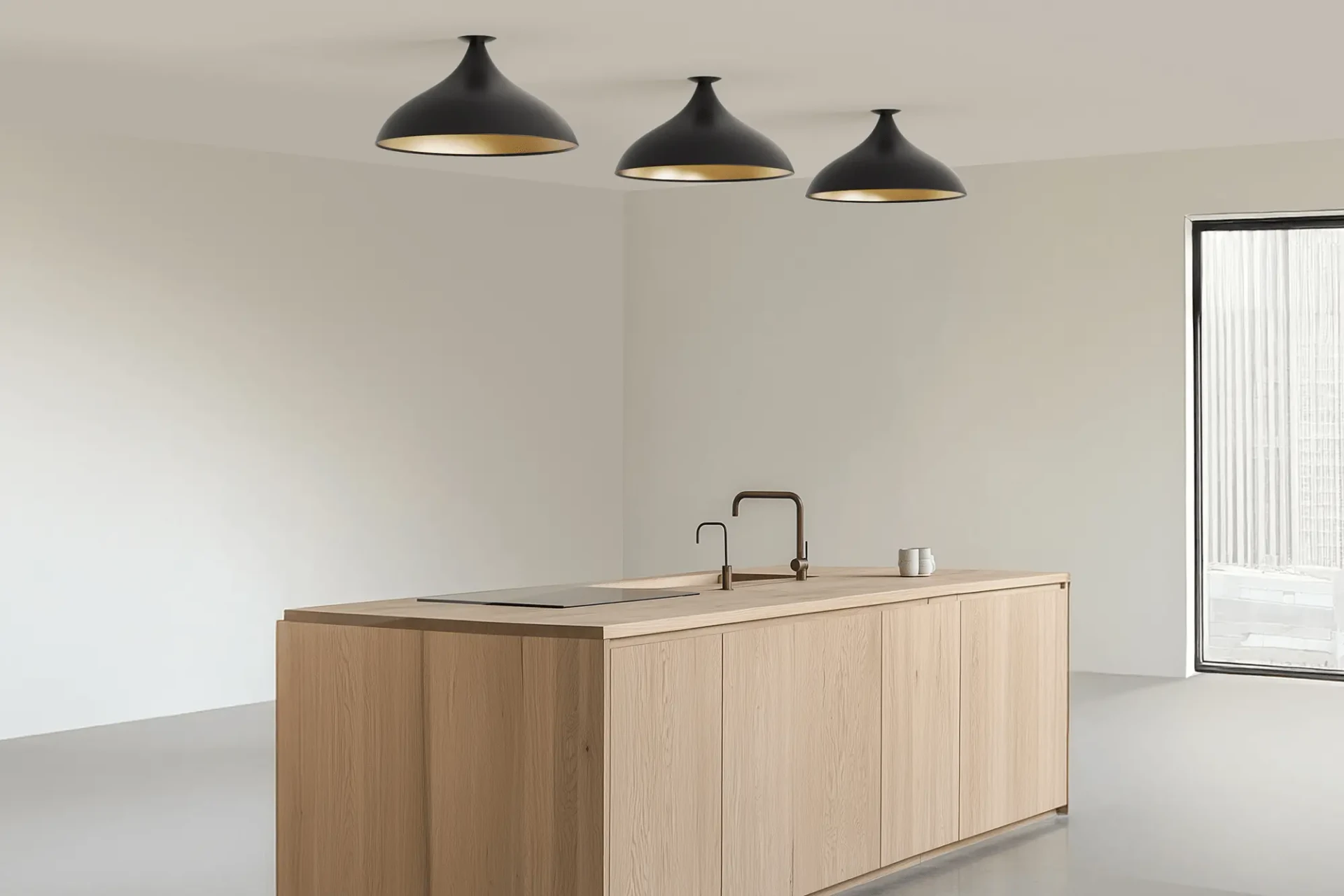 BLACK - Three Pablo Swell Flush Lamps Wide, matte black exterior, brass interior, in a modern kitchen, wide angle view.