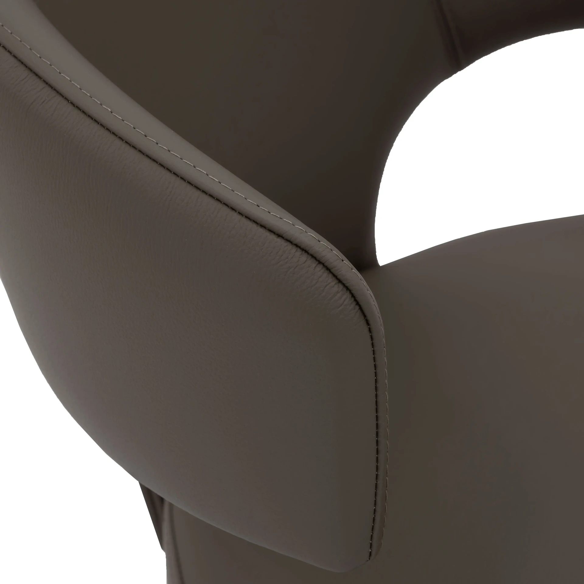 BARK BROWN || Closeup - Close-up side view of a modern grey leather armchair featuring detailed stitching and a curved armrest.