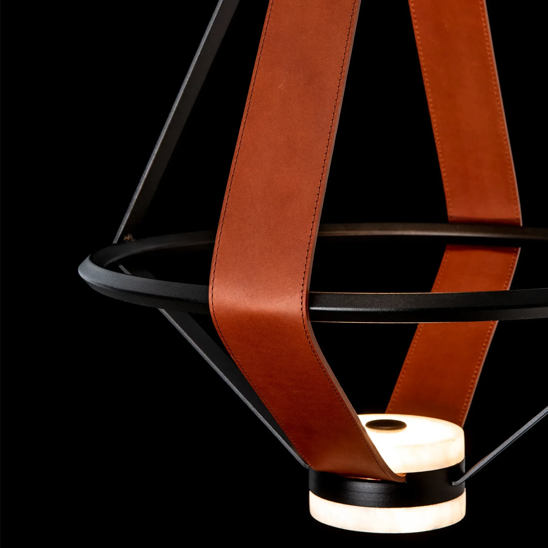 Closeup - Close-up of Aspen Led Small Pendant in Black Metal Finish and Chestnut Leather with Alabaster, showing integrated LED light.