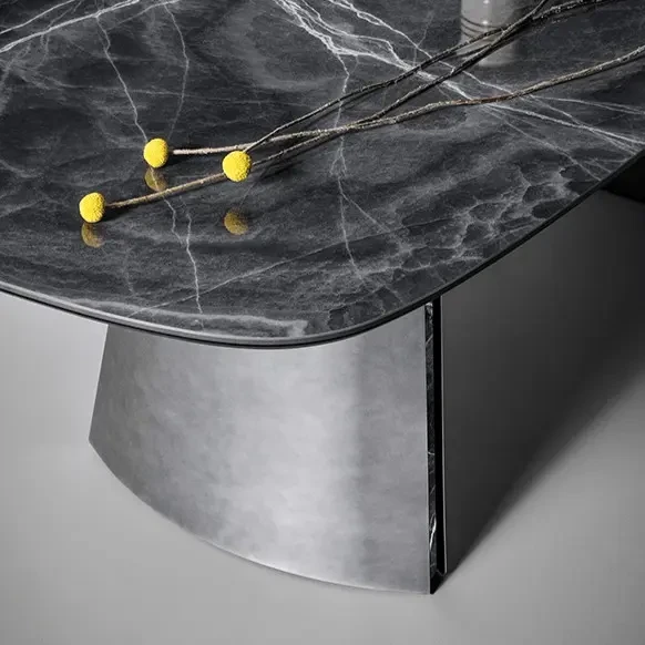 Closeup - Bonaldo Torii Dining Table, modern style, glossy black onyx ceramic top, clouded chrome metal base, close-up angle.