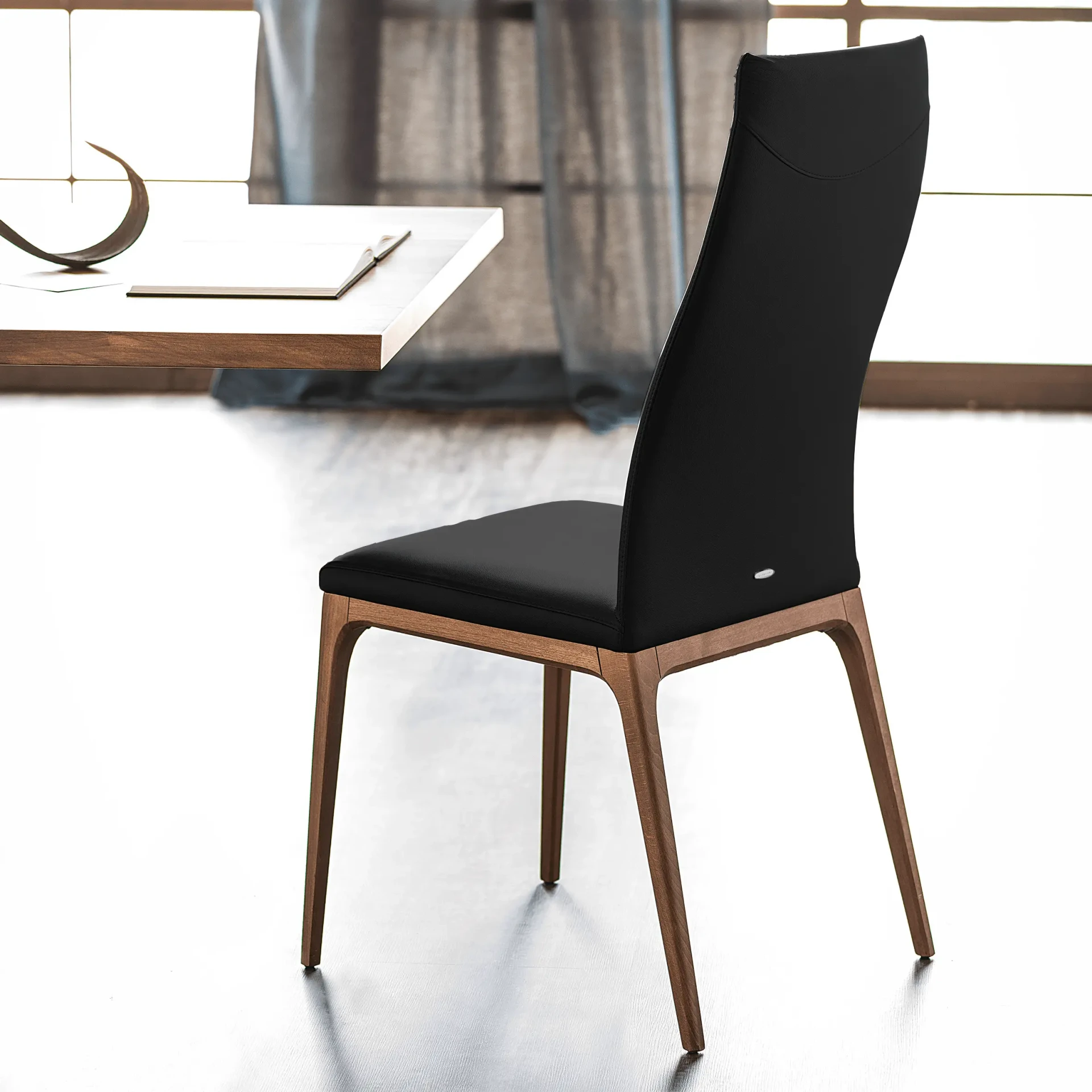 NERO || WALNUT - Cattelan Arcadia High Back Side Chair in Nero Soft Leather with Walnut Stained Beech Frame, side view in dining room setting.