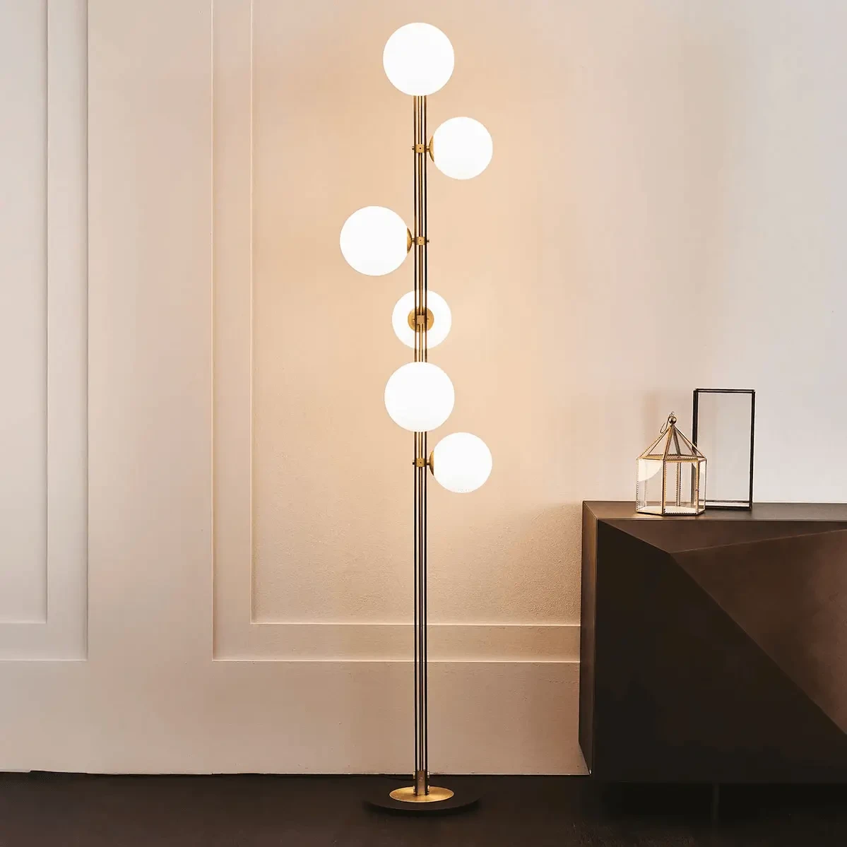 Cattelan Planeta Floor Lamp in Brushed Brass with white blown glass globes, mid-century modern style, living room view.