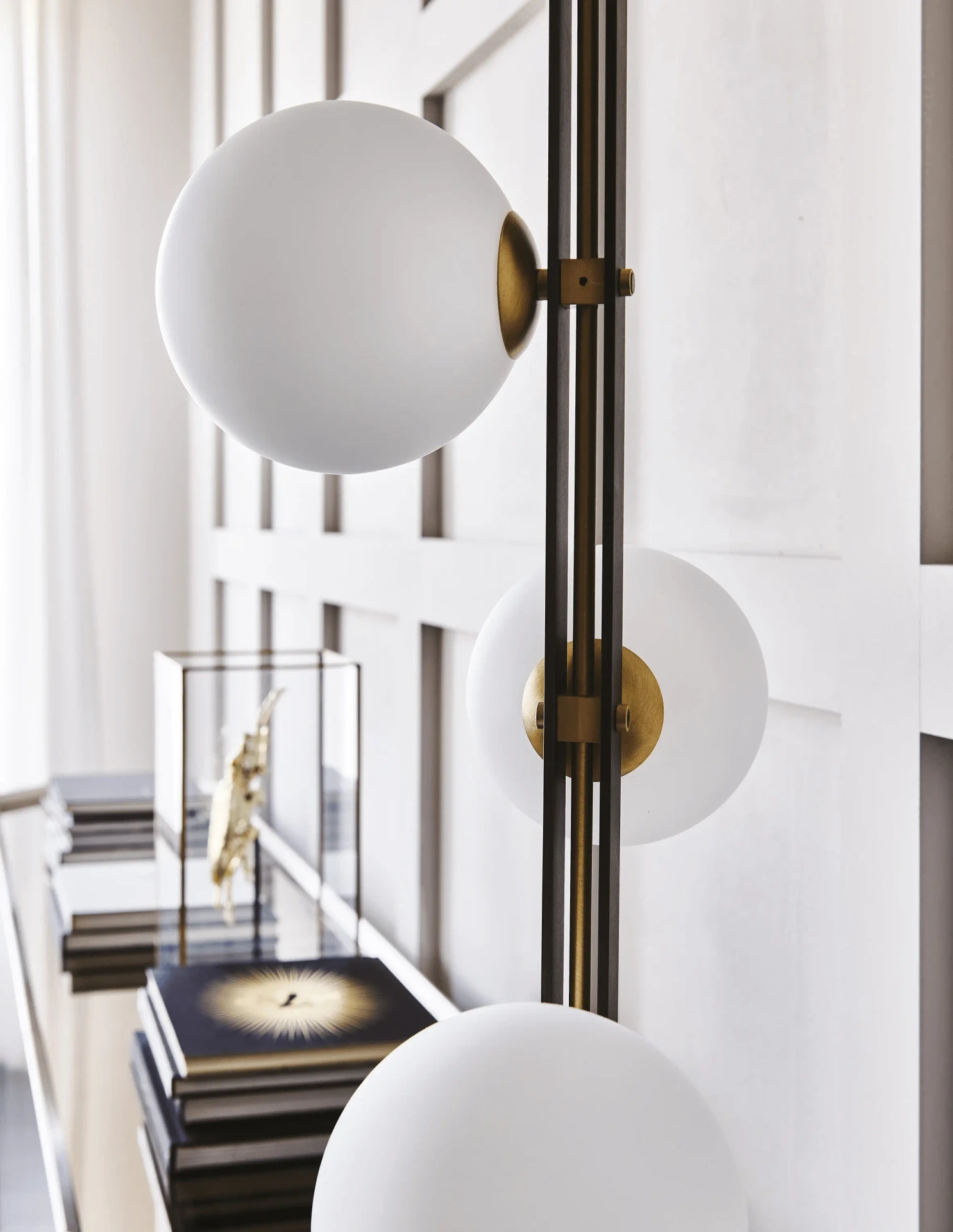 Cattelan Planeta Floor Lamp, modern burnished steel and brushed brass with white blown glass globes, close-up lifestyle view.