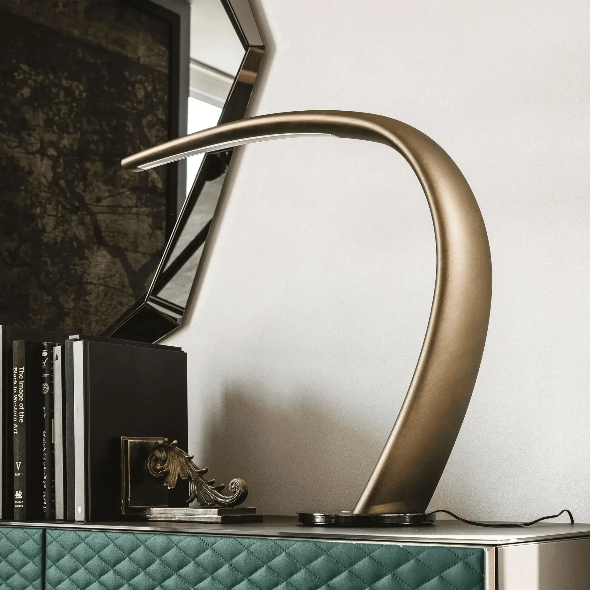 Cattelan Mamba Table Lamp in brushed bronze polyurethane with black chrome base, side view in a modern office setting.