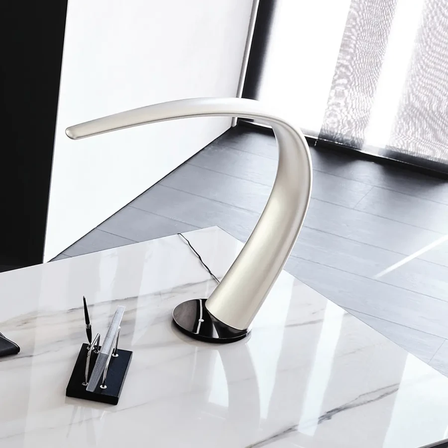 Cattelan Mamba Table Lamp in Titanium polyurethane with black chrome base, modern curved design, office setting, 3/4 view