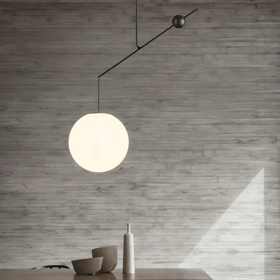 BLACK - Malamata Suspension light, modern matt black steel and opal glass globe, dining room setting, front view.