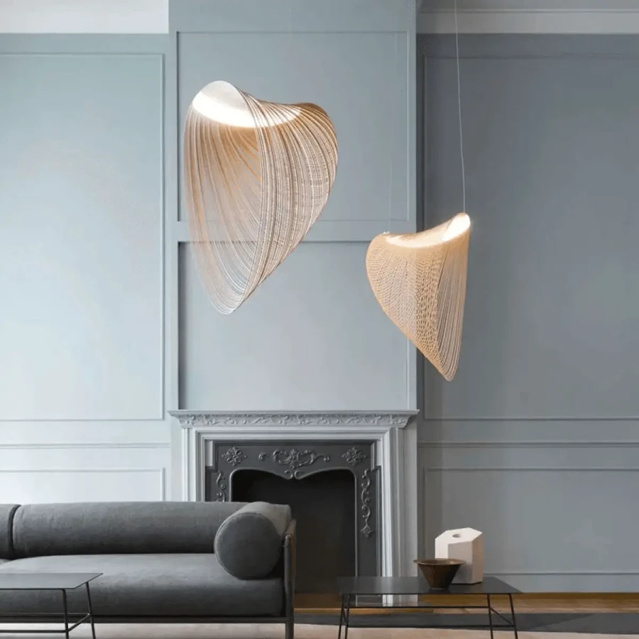 Two Illan Suspension Small pendant lights, lasercut birch plywood, dimmable 25W LED, in a modern living room, front view.