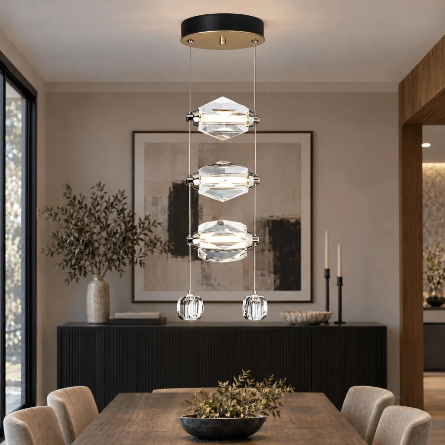 Gatsby 3-light Pendant in Modern Brass Finish and Crystal with integrated LED, front view in a modern dining room setting.