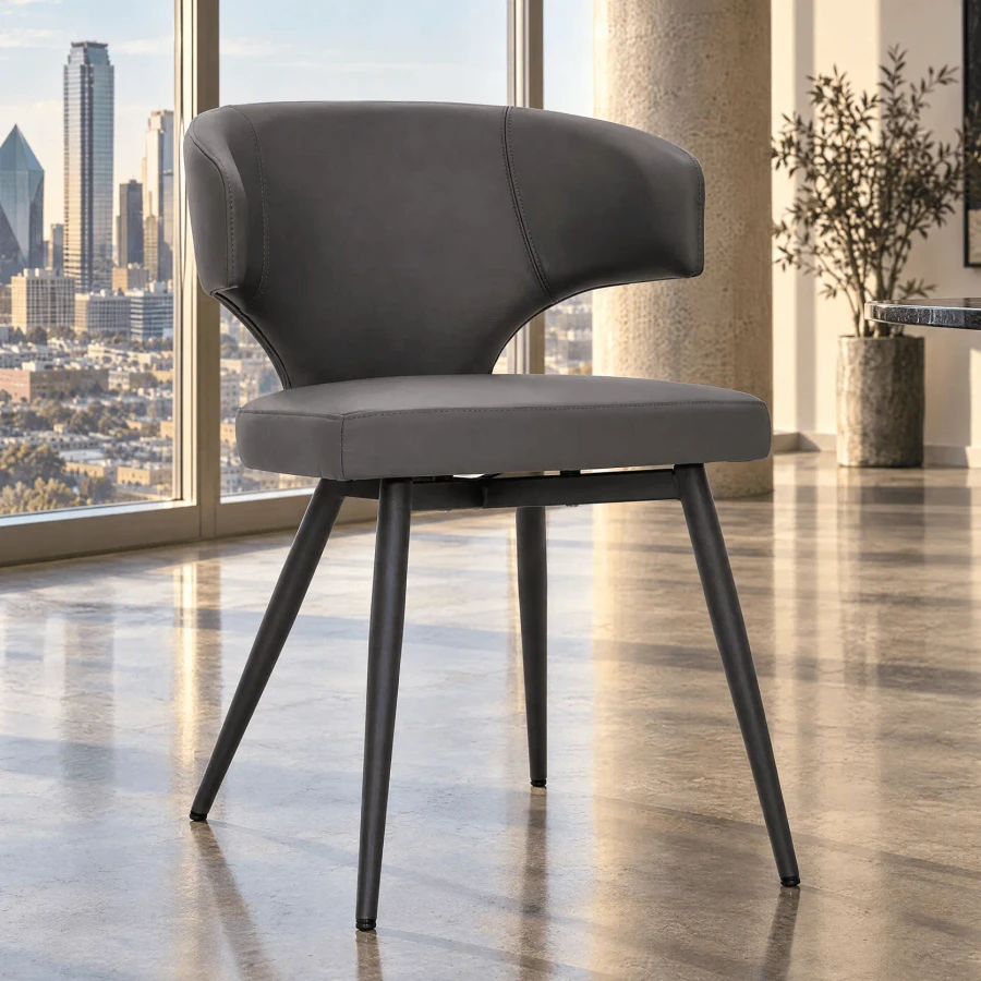 Wing Side Chair in grey leather with charcoal powder coat metal legs, angled view in a modern dining room setting.