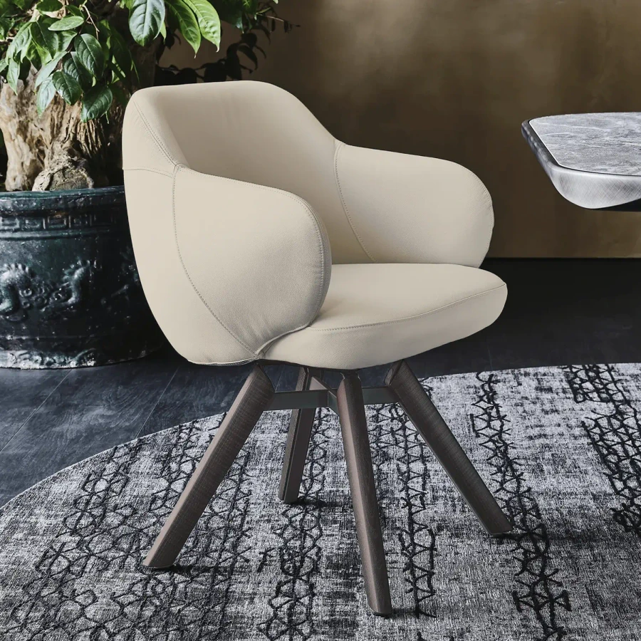Cattelan Bombe Swivel Chair in Lino Soft Leather with Burned Oak Legs, modern style, 3/4 view in a dining room setting.