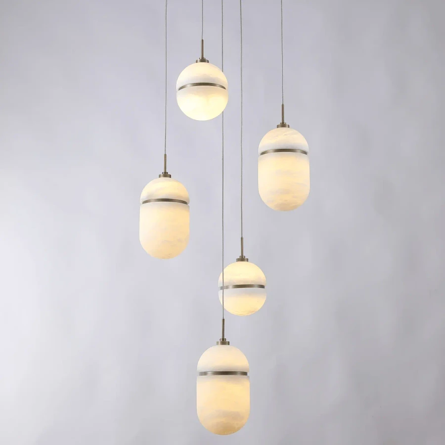 Sedona 5-light chandelier, modern style, aged brass and alabaster globes, multi-pendant design, front view.