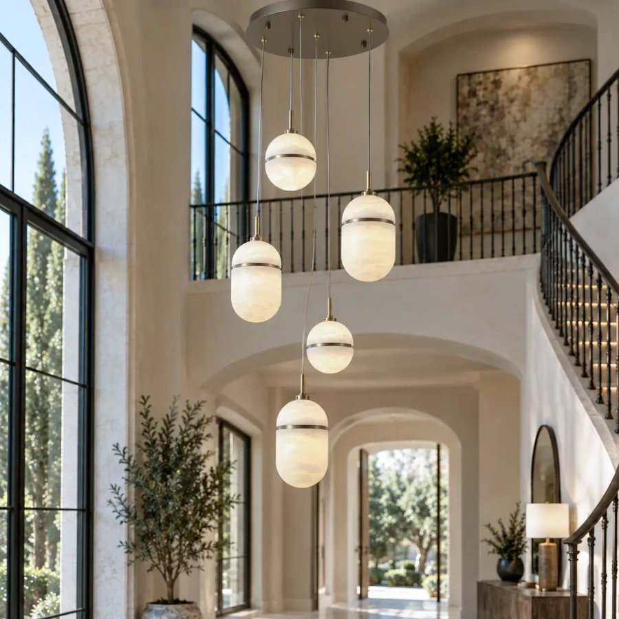 Sedona 5-light chandelier, Aged Brass with Alabaster Globes, modern style, multi-pendant, eye-level view in luxury foyer.