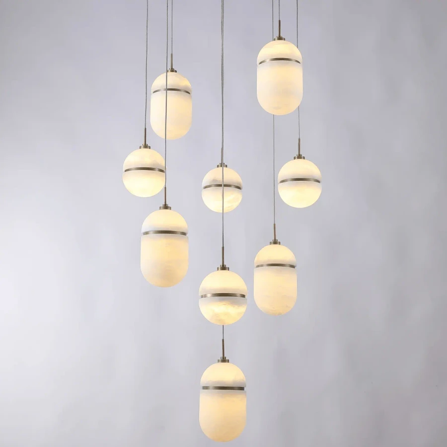 Sedona 9-light chandelier, aged brass and alabaster globes, modern style, front view against a plain white background.