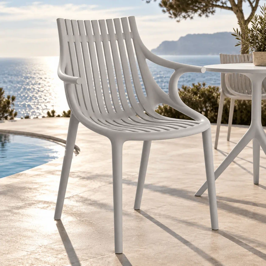 ECRU || WITH ARMS - Vondom Ibiza Chair, modern ecru injection polypropylene outdoor chair with slatted back, side view on a sunny patio.
