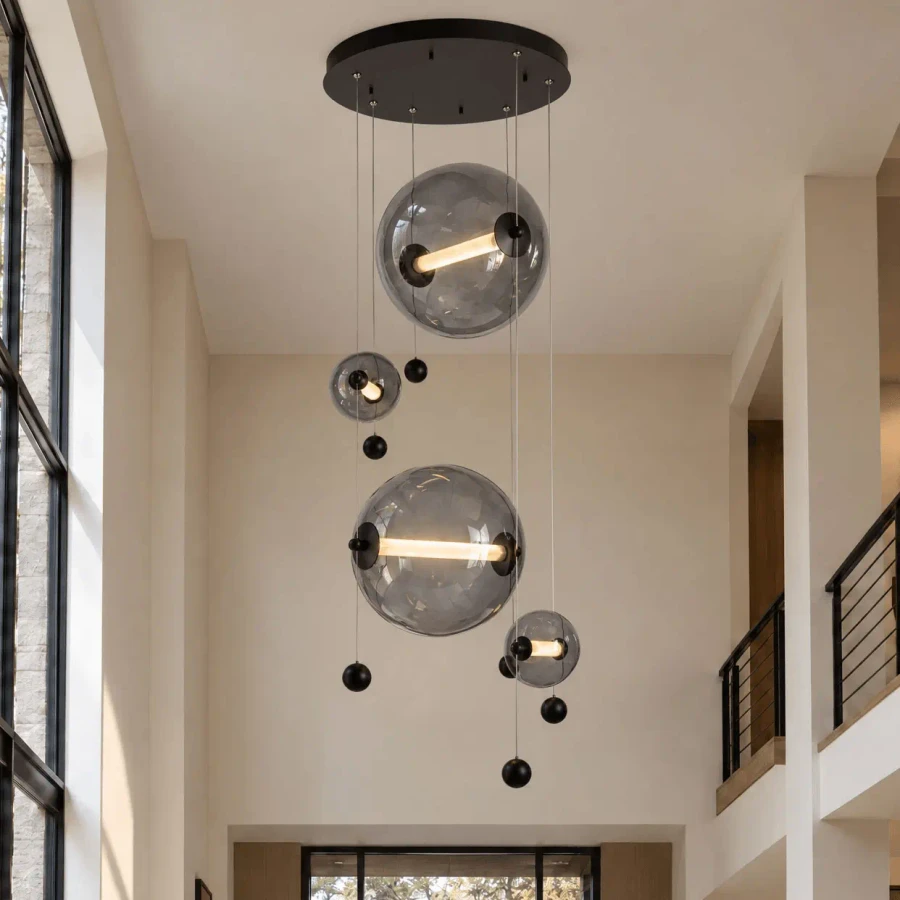 Abacus 4-light round pendant in black finish and cool grey glass with LED bulbs, low angle view in a modern living room.