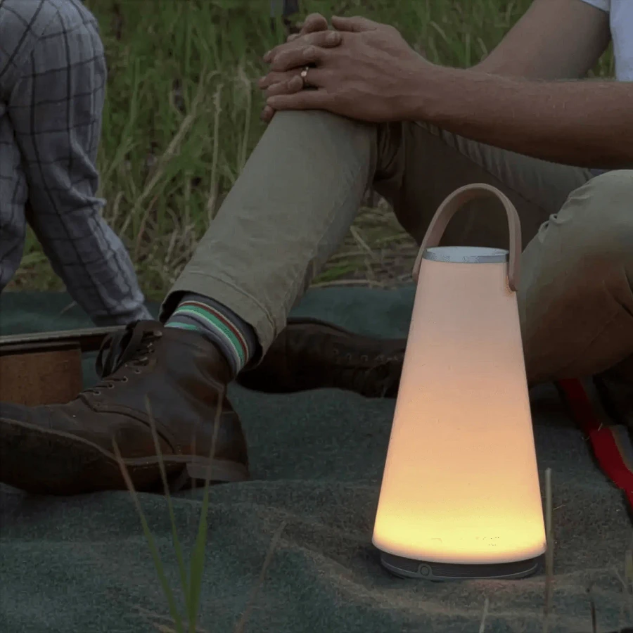 Pablo Uma Sound Lantern, Silver/White, Tan Leather Strap, portable Bluetooth speaker, outdoor lifestyle side view.