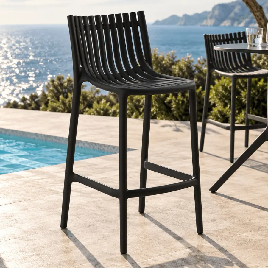 BLACK - Vondom Ibiza Bar Stool, modern black injection polypropylene, slatted back, outdoor patio setting, three-quarter view.