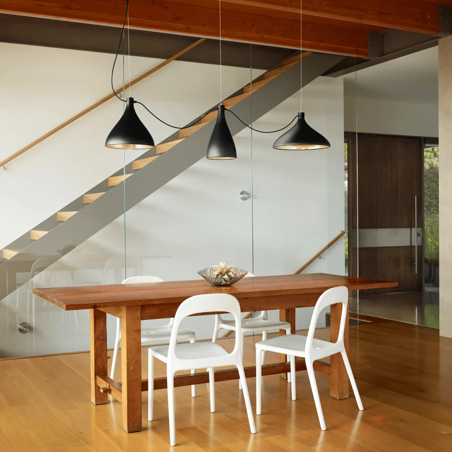 BLACK - Pablo Swell String Mix Chandelier, matte black exterior, brass interior, 3-light pendant in modern dining room, eye-level