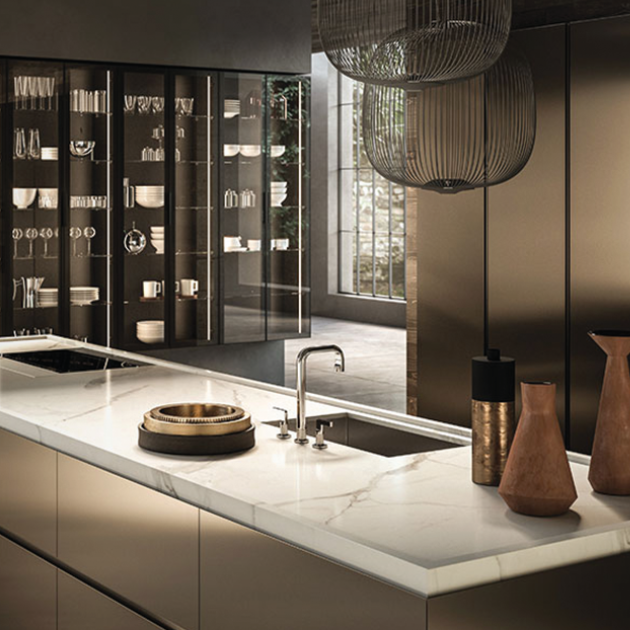 Kitchen island in front of glass cabinets