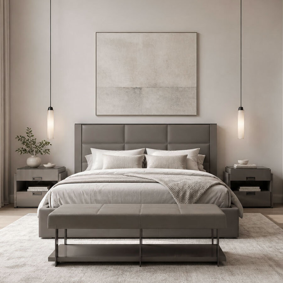 Modern minimalist bedroom suite featuring a grey leather tufted bed, matching nightstands, a leather bench at the foot of the bed, and warm hanging pendant lights.