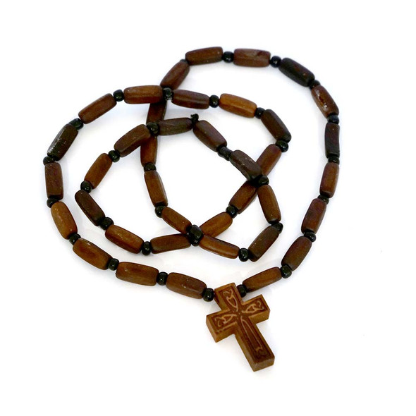 Dark wooden bead necklace with a carved Celtic-style cross pendant.