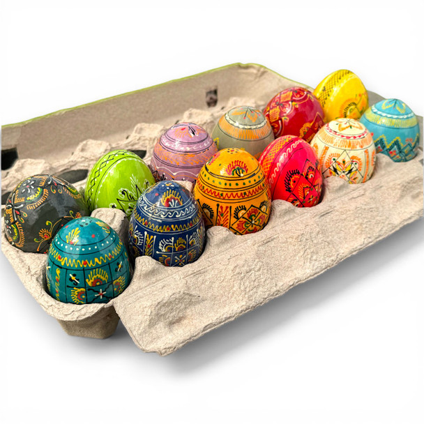 A dozen brilliantly colored Ukrainian Pysanki eggs in a carton. 