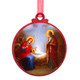 Circular ornament showing Virgin Mary lying beside baby Jesus in a manger, both with golden halos.