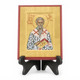 Black icon stand pictured with icon of saint Ambrose 